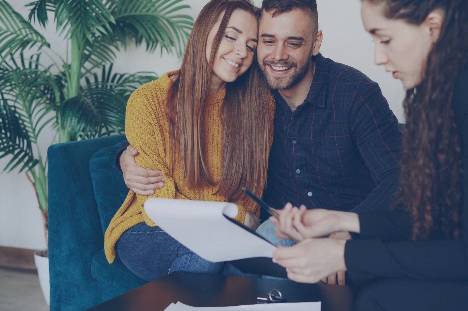Smiling couple reviewing their plan with a financial advisor
